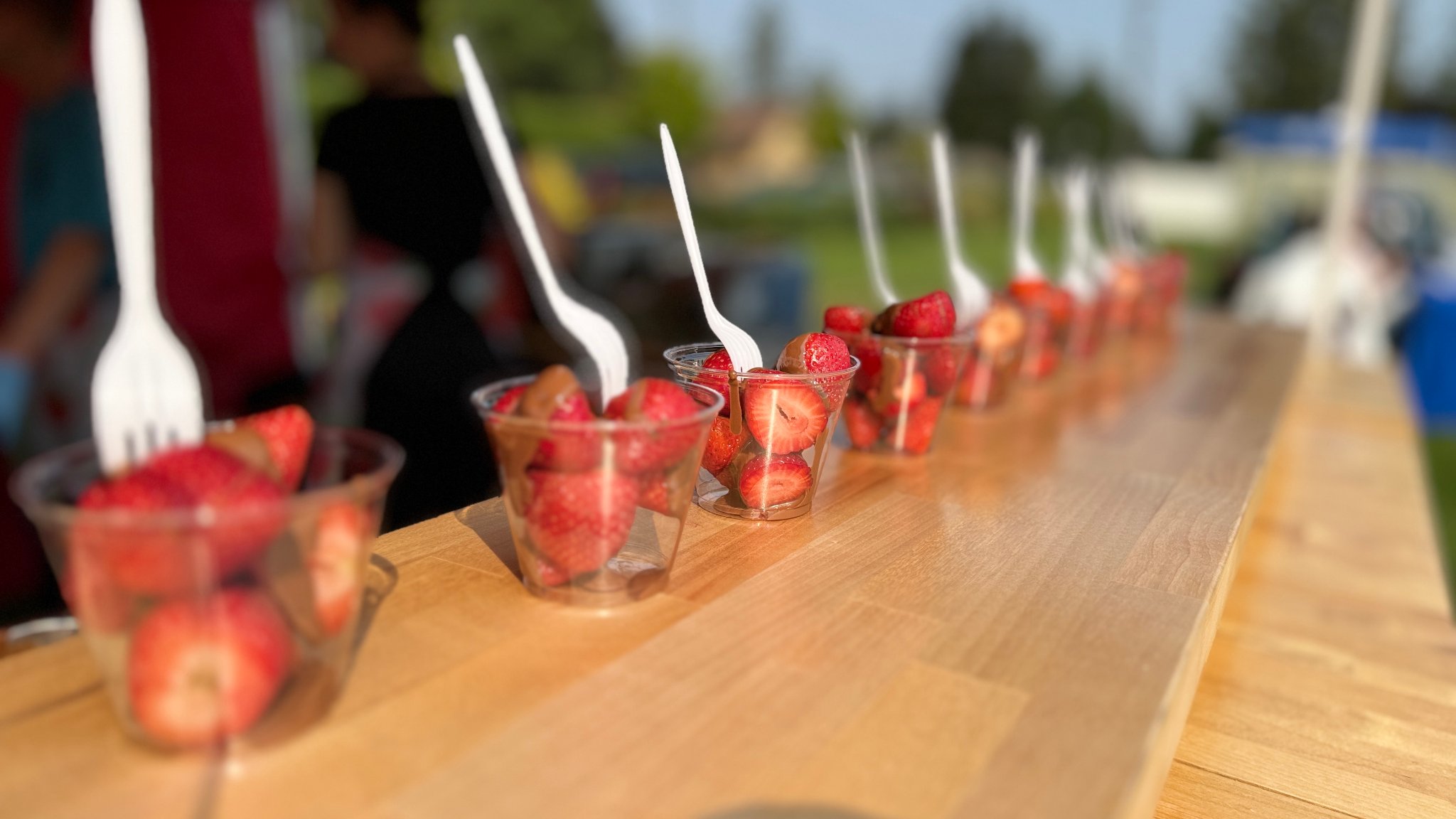 Sweet Mama's dessert cups lined up at an outdoor catering event